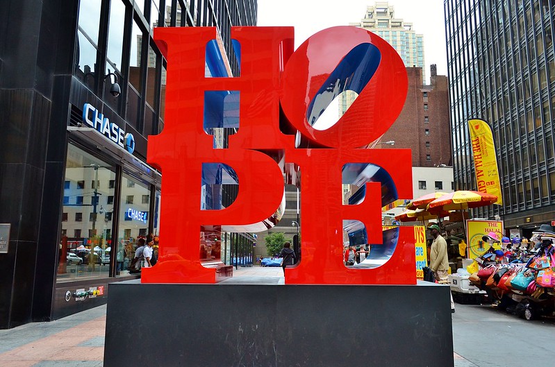 Red hope sign, parody of love sculpture.